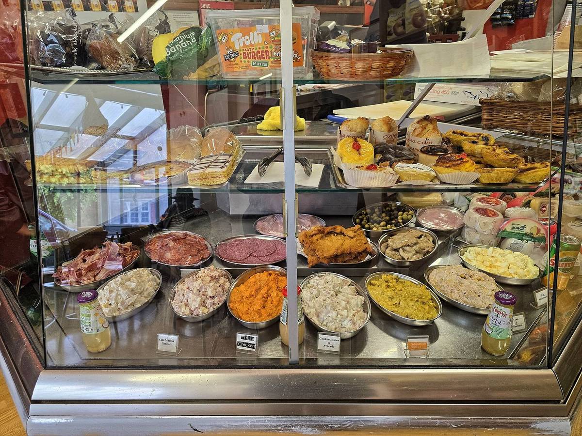 The front cabinet full of salads, dips and cakes
